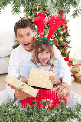 Composite image of surprised father and his girl opening christm