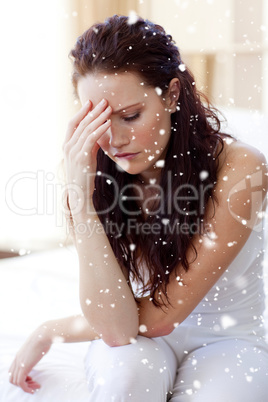 Composite image of beautiful woman having a headache in bed