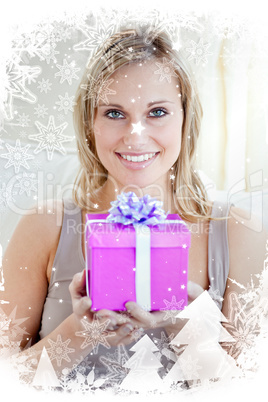 Woman holding a present in a living room