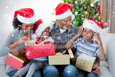 Happy family playing with christmas presents