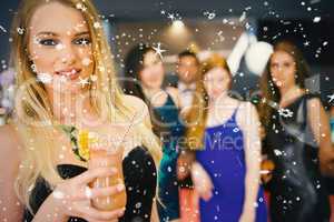 Blonde woman standing in front of her friends holding cocktail