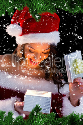 Pretty brunette in santa outfit opening gift