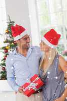 Composite image of smiling couple at christmas