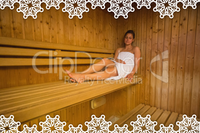 Calm brunette relaxing in a sauna