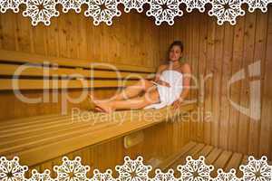 Calm brunette relaxing in a sauna