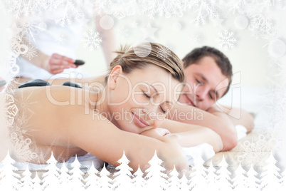 Young couple having a massage with hot stone