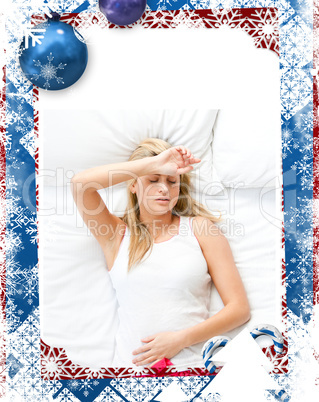 Upset woman having a migraine lying on a bed at home