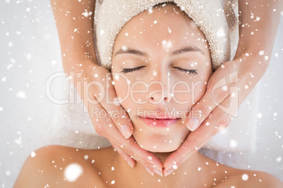 Attractive woman receiving facial massage at spa center