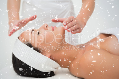 Peaceful brunette getting reiki therapy