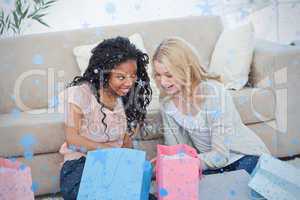 Two smiling women with shopping bags