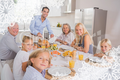Composite image of father cutting turkey and looking at camera