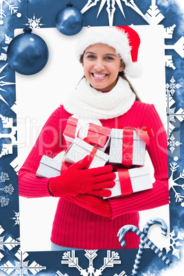 Composite image of beautiful festive woman holding gifts
