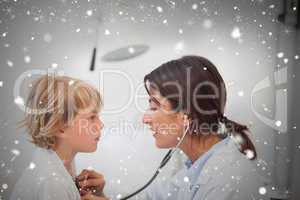 Composite image of doctor auscultating a child with a stethoscop