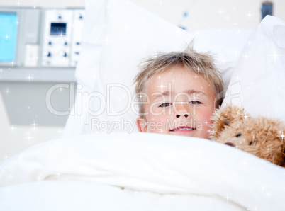 Composite image of sick adorable little boy lying in a hospital