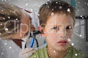 Composite image of boy being examined by doctor with otoscope