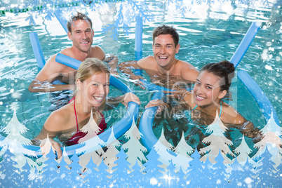 Happy fitness class doing aqua aerobics with foam rollers Happy fitness class doing aqua aerobics with foam rollers