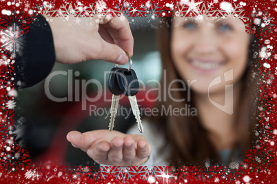 Composite image of woman smiling while receiving car keys