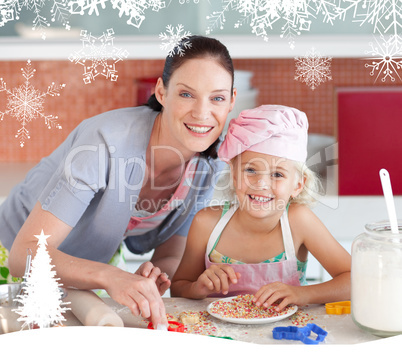 Laughing mother and her daughter baking in a kitchen