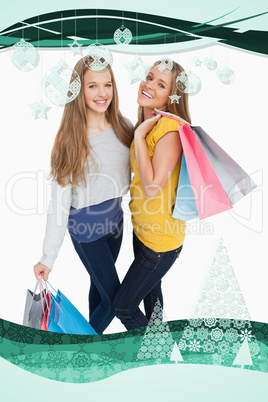 Two beautiful young women holding shopping bags