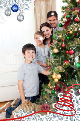 Happy family decorating a christmas tree with boubles and presen