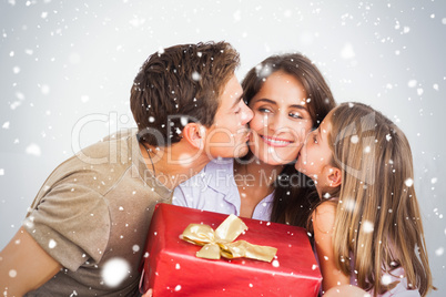 Composite image of father and his daughter offering a red gift