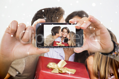Hand holding smartphone showing photo