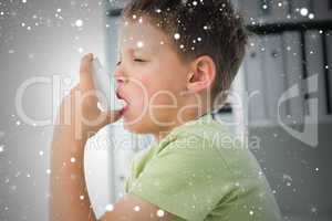 Boy using an asthma inhaler in clinic