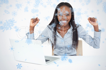 Cheerful businesswoman working with a laptop