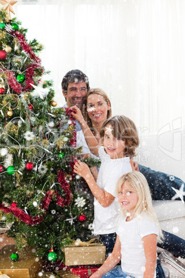 Composite image of parents and their children decorating a chris