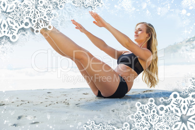 Fit blonde in core balance pilates pose on the beach