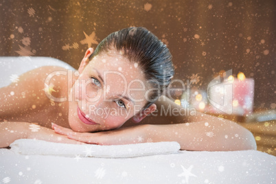 Beautiful woman lying on massage table at spa center