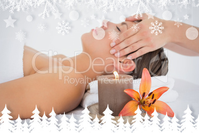 Attractive woman receiving head massage at spa center