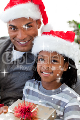 Composite image of portrait of an father and son holding a chris