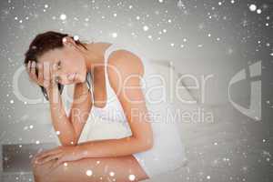 Composite image of ill feeling woman sitting on her bed