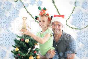 Happy father and daughter decorating together the christmas tree