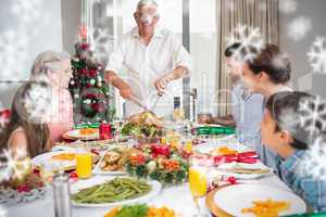 Extended family at dining table for christmas dinner in house