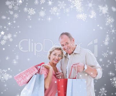 Composite image of couple with shopping bags