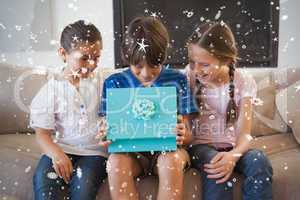 Composite image of happy young kids with gift box