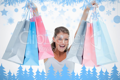 Cheerful woman holding shopping bags