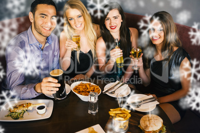 Happy friends having dinner together