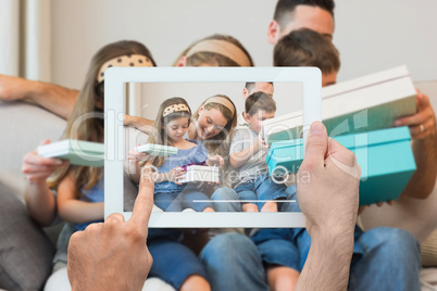 Composite image of hand holding tablet pc