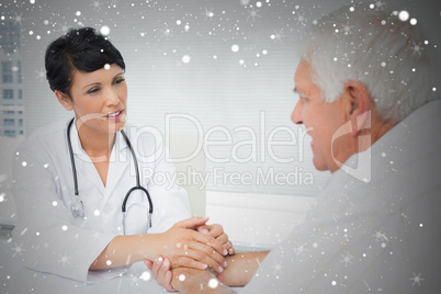 Composite image of female doctor holding senior patients hands