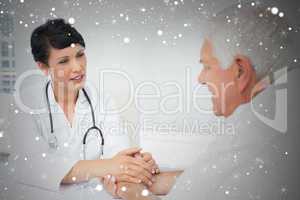 Composite image of female doctor holding senior patients hands