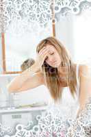 Dejected woman having a headache sitting in the bathroom