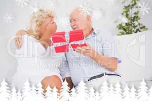 Composite image of old man offering a gift to the elderly woman