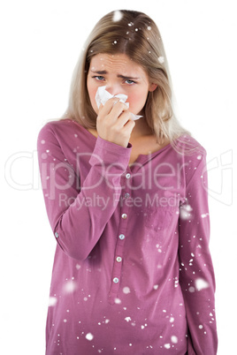 Woman blowing her nose while looking at the camera