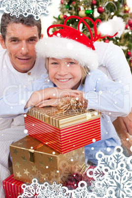 Portrait of a father and his son holding christmas presents