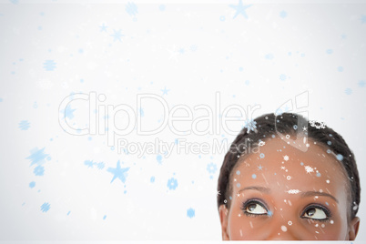 Close up of woman looking upwards diagonally on white background