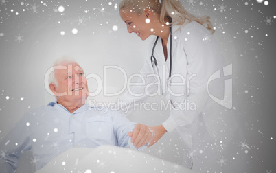 Composite image of doctor helping elderly man to sit up