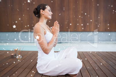 Content brunette in white sitting in lotus pose